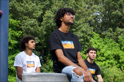 three men siting down looking out in a distance wearing keep moving tees