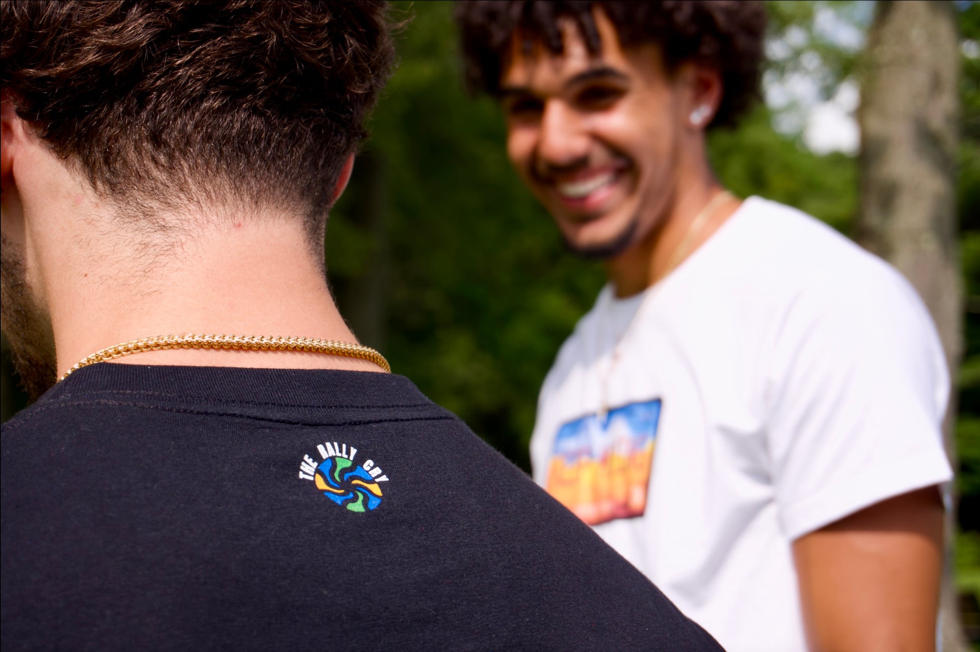 showing back logo detail on black tee